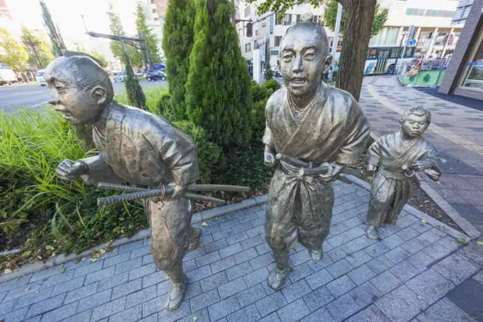 Framed Print : Japan, Kyushu, Kagoshima, Kagoshima City, Statues depicting Citizens Running to Framed Print : Japan, Kyushu, Kagoshima, Kagoshima City, Statues depicting Citizens Running to