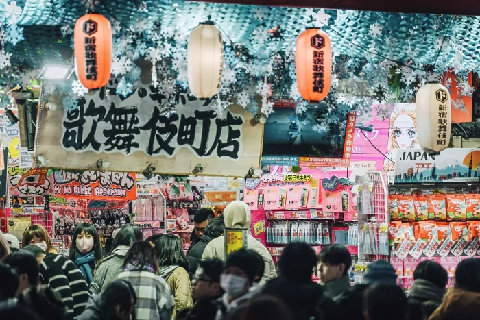 Framed Print : Japan, Tokyo, Shoppers browse goods in a busy shop in Kabukicho district Framed Print : Japan, Tokyo, Shoppers browse goods in a busy shop in Kabukicho district