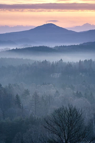 Jedlova mountain in Lusatian mountains rising above fog taken from Krizovy vrch hill at