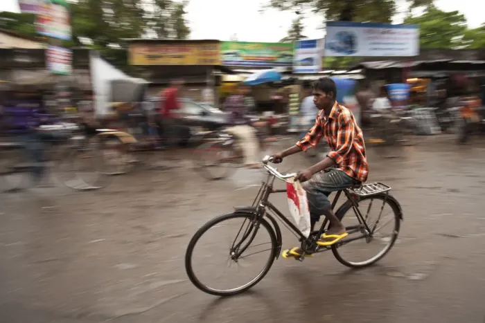Framed Print : Jessore, Bangladesh. A man cycles to work through the centre of town Framed Print : Jessore, Bangladesh. A man cycles to work through the centre of town