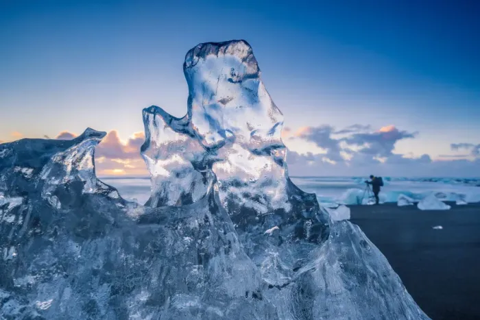 Framed Print : Jokulsarlon, Iceland. A transparent block of ice and a photographer on