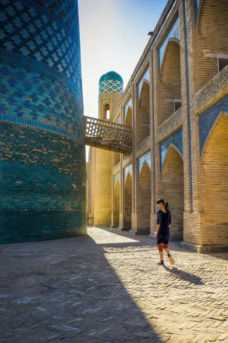 Framed Print : Kalta Minor minaret, Khiva. Uzbekistan, Central Asia. Woman walking near the minaret Framed Print : Kalta Minor minaret, Khiva. Uzbekistan, Central Asia. Woman walking near the minaret