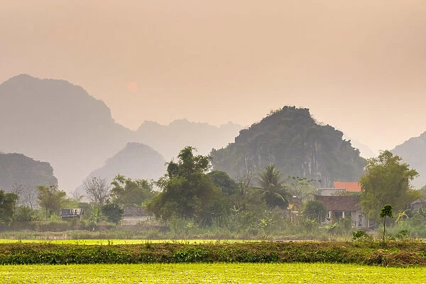 Karst landscape and rice fields near Tam Cốc village at sunset, Hoa Lư