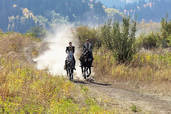 Kazakhstan, Almaty, a couple of Kazakhs ride their horses
