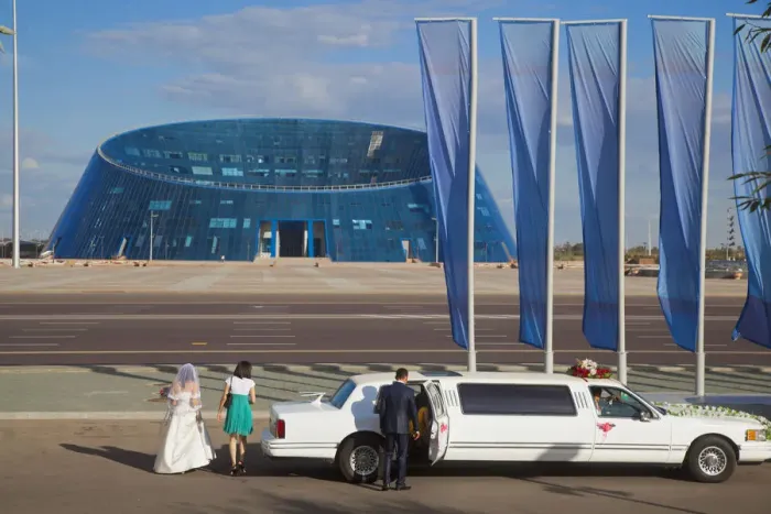 Framed Print : Kazakhstan, Astana, Shabyt Palace of Arts, Wedding party arrive opposite Palace in Framed Print : Kazakhstan, Astana, Shabyt Palace of Arts, Wedding party arrive opposite Palace in