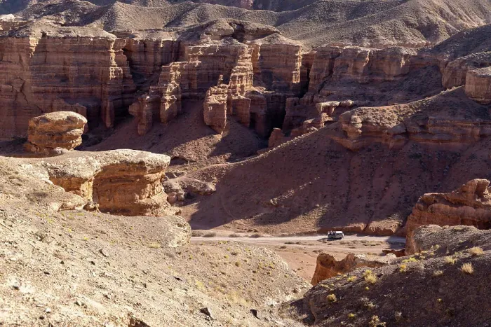 Framed Print : Kazakhstan, Charyn Canyon, an old bus drives through the canyon