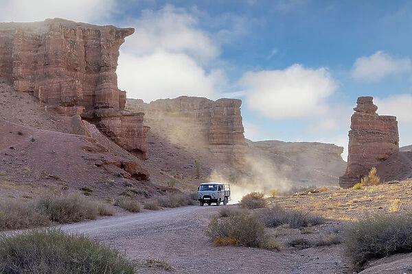 Kazakhstan, Charyn Canyon, an old bus drives through the canyon