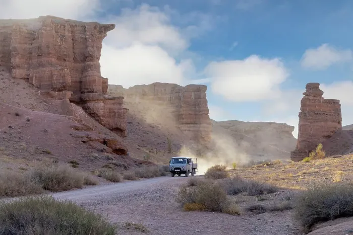 Framed Print : Kazakhstan, Charyn Canyon, an old bus drives through the canyon Framed Print : Kazakhstan, Charyn Canyon, an old bus drives through the canyon