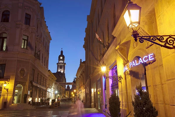 Kiraly utca and Town Hall illuminated at dusk, Pecs, Hungary