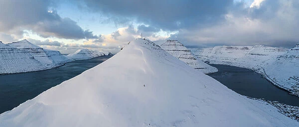 Klakkur mountain covered by snow. In the background the islands of Kalsoy and Kunoy. Borðoy, Faroe Islands