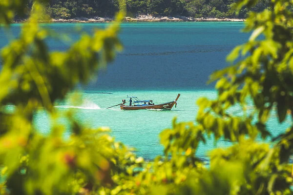 Ko Lipe, Satun Province, Thailand. Traditional long tail boat in turquoise waters