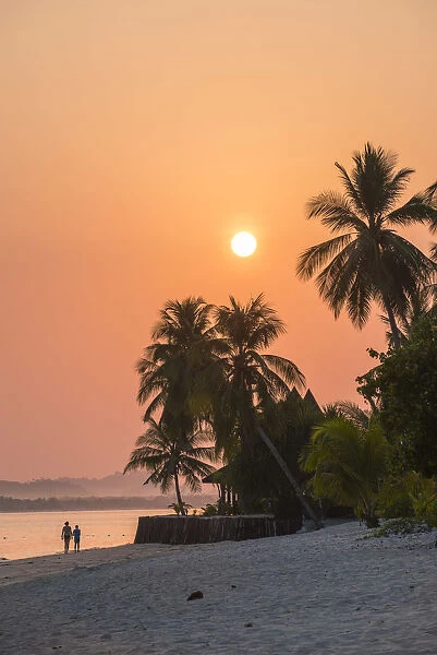 Ko Muk (Ko Mook), Trang Province, Thailand. Tourists walking on the beach at sunrise (PR)