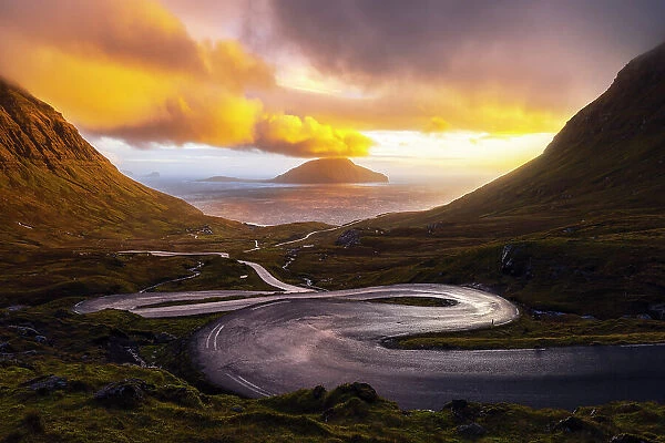 Koltur island with a bendings road in the foreground, Streymoy, Torshavnar municipality, Faroe Islands, Denmark