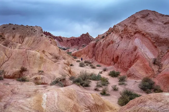 Framed Print : Kyrgyzstan, Issyk Kul Lake, Fairytale canyon (Skazka canyon), a person walks through the red canyon Framed Print : Kyrgyzstan, Issyk Kul Lake, Fairytale canyon (Skazka canyon), a person walks through the red canyon