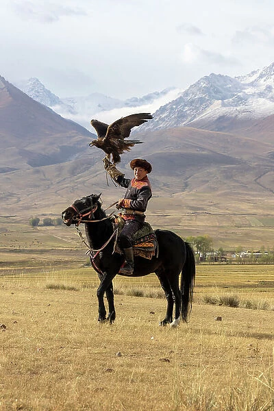 Kyrgyzstan, Issyk Kul Lake, golden eagle hunter on horseback