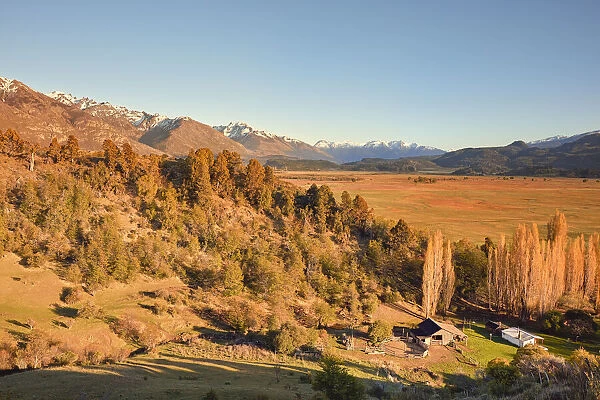 The laguna Terraplen valley at sunrise with the Andes mountains snowy peaks in background, Trevelin, Chubut, Patagonia, Argentina
