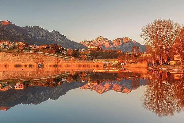 Lake Annone with Civate village and Lecco mountains reflected, Brianza, Lecco province, Lombardy, Italy