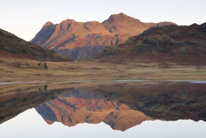 Framed Print : The Langdale Pikes glow with the first light of dawn, reflected in Blea Tarn, Lake District National Park, Cumbria, England. Autumn (November) 2009 Framed Print : The Langdale Pikes glow with the first light of dawn, reflected in Blea Tarn, Lake District National Park, Cumbria, England. Autumn (November) 2009