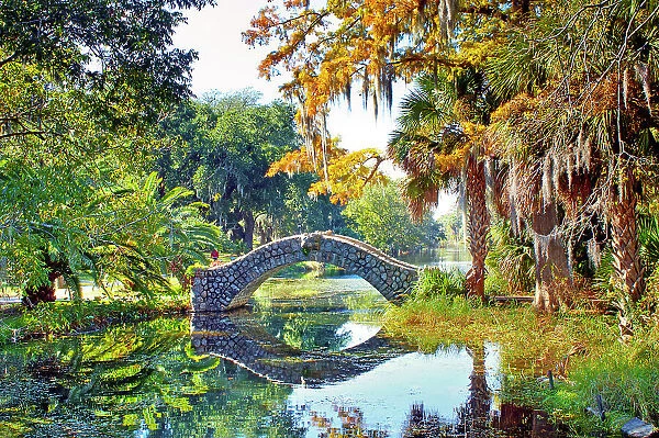 Langles Bridge, built in 1902, is an old stone bridge that crosses a preserved bayou in City Park, New Orleans. The park holds the world's largest collection of mature live oaks. Louisiana, USA