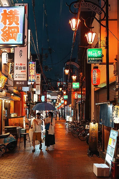 Lanterns and people on a rainy night in Osaka, Japan