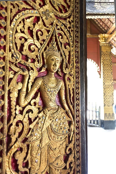 Laos, Luang Prabang. Decoration on a door, Wat Xieng Thong temple