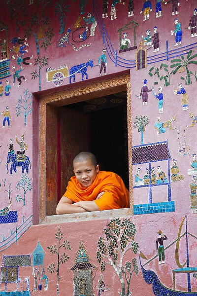 Laos, Luang Prabang, Wat Xieng Thong, Monk at Window of the Reclining Buddha Sanctuary