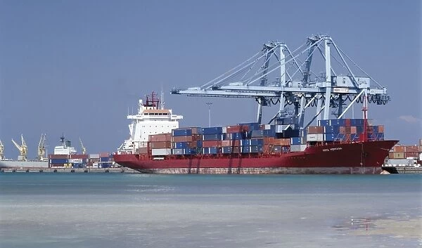 A large container vessel discharges its cargo at the port of Djibouti