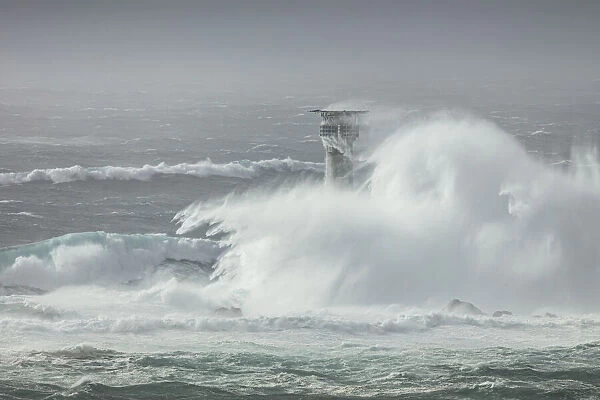 Large waves crashing over Longships Lighthouse, Lands End, Cornwall, England, UK