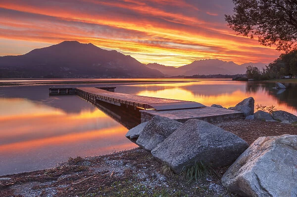 Lecco mountains on fire, sunrise on lake Pusiano, Como and Lecco province, Brianza