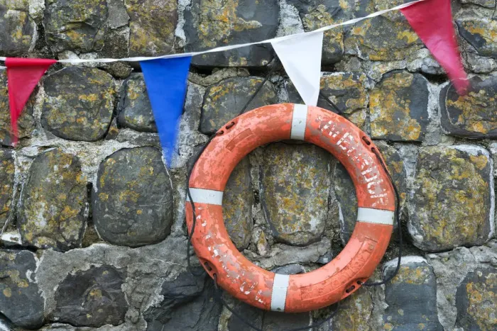Framed Print : Life ring and bunting on the old harbour wall at Clovelly, Devon, England. Summer Framed Print : Life ring and bunting on the old harbour wall at Clovelly, Devon, England. Summer