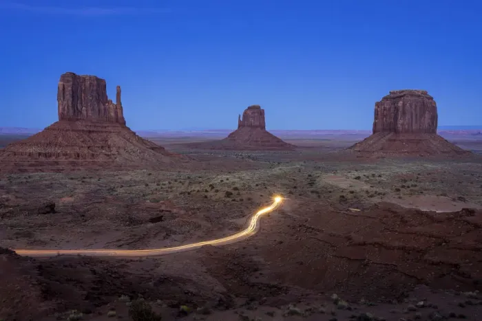 Framed Print : Light trail from car driving on scenic drive road near The Mitten Buttes in Monument Framed Print : Light trail from car driving on scenic drive road near The Mitten Buttes in Monument