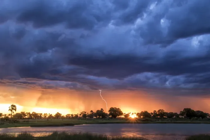 Framed Print : Lightning shoots from a summer thunderstorm as the sun sets behind it, Okavango Delta Framed Print : Lightning shoots from a summer thunderstorm as the sun sets behind it, Okavango Delta