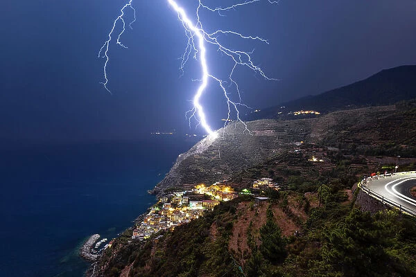lightning strikes the vineyards of Riomaggiore during an summer night, National Park of Cinque Terre, Riomaggiore, La Spezia, Liguria, Italy