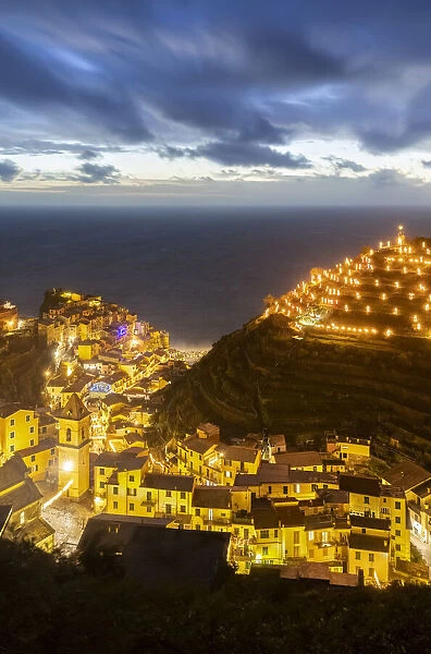The lights of the sea village of Vernazza with the typical crib on the hill