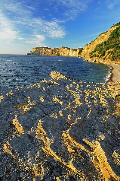 Limestone along the Atlantic shoreline at sunrise Forillon National Park, Quebec, Canada