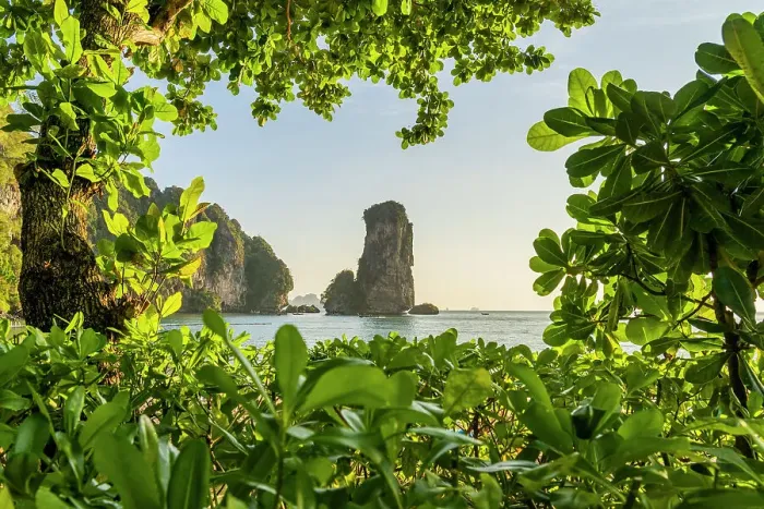 Framed Print : Limestone Karst tower framed by trees on Pai Plong Beach, Ao Nang, Krabi, Thailand