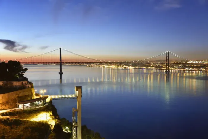 Framed Print : Lisbon and 25 de Abril bridge over the Tagus river, at dusk, seen from Almada. Portugal