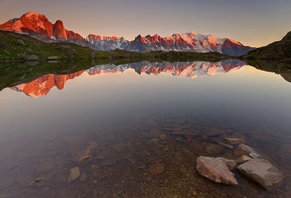 Little alpine lake, reflecting the Mont Blanc massif, in the sunset (French alps)
