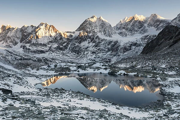 The little lake of Forbici during sunrise and in background Bernina Group, Valmalenco