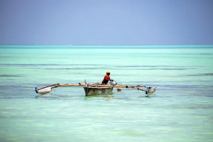 Framed Print : Local fisherman bailing out his old wooden dhow, Nungwi, Zanzibar, Tanzania Framed Print : Local fisherman bailing out his old wooden dhow, Nungwi, Zanzibar, Tanzania