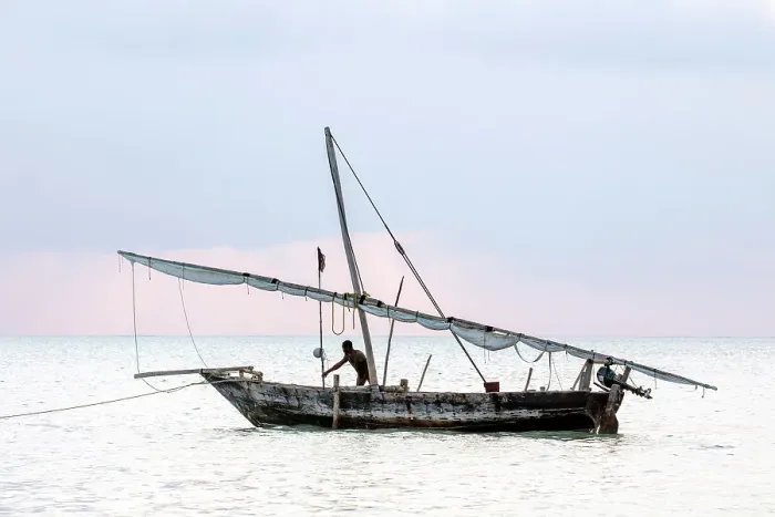 Framed Print : Two local fisherman on his traditional dhow at sunrise, Jambiani, Zanzibar, Tanzania Framed Print : Two local fisherman on his traditional dhow at sunrise, Jambiani, Zanzibar, Tanzania