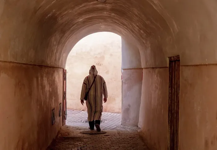 Framed Print : Local man in djellaba, walking through an alleyway on cobbled street, Medina, Marrakech, Morocco Framed Print : Local man in djellaba, walking through an alleyway on cobbled street, Medina, Marrakech, Morocco