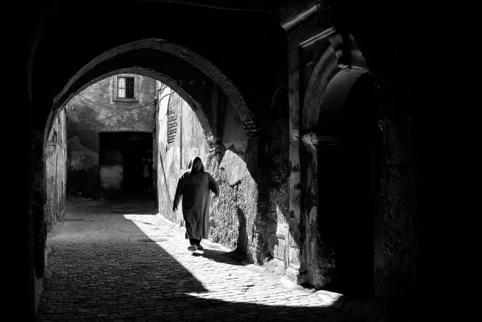 Framed Print : Local man in djellaba, walking through an archway on cobbled street, Medina, Marrakech, Morocco Framed Print : Local man in djellaba, walking through an archway on cobbled street, Medina, Marrakech, Morocco