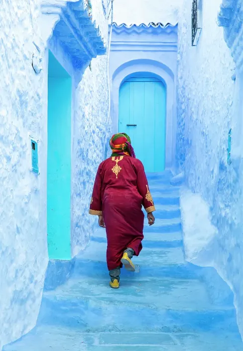 Framed Print : Local man wearing Djellaba walking up flight of steps in blue street, Chefchaouen, Rif Mountain, Morocco