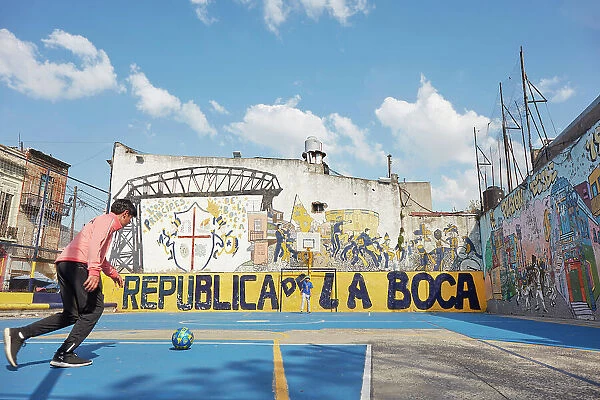 Local people playing football in La Boca district, Buenos Aires, Argentina