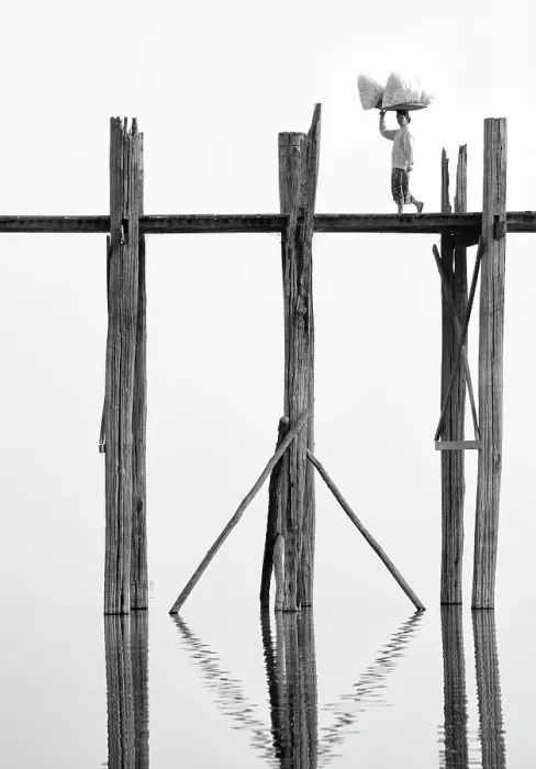 Framed Print : Local woman carrying goods on her head across U Bein Bridge, the world's longest teak foot bridge spanning 1300 yards over Taungthaman Lake, Amarapura, near Mandalay, Myanmar Framed Print : Local woman carrying goods on her head across U Bein Bridge, the world's longest teak foot bridge spanning 1300 yards over Taungthaman Lake, Amarapura, near Mandalay, Myanmar