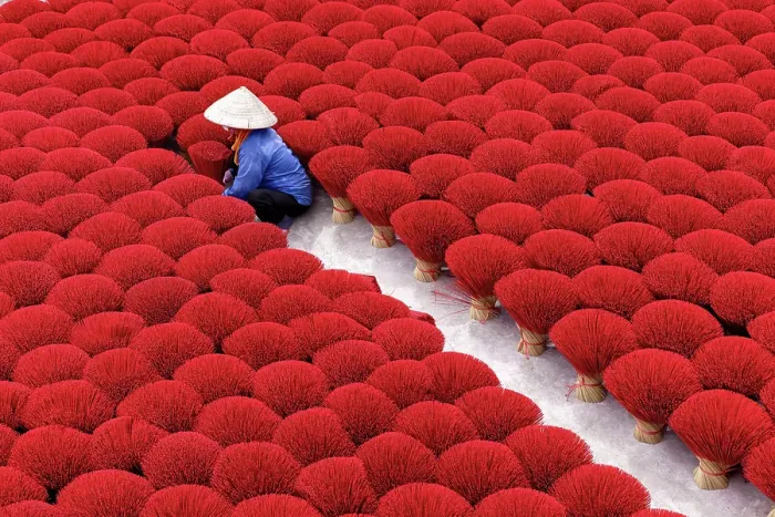 Framed Print : Local woman laying out colourful Incense sticks to dry, Quang Phu Cau village, near Hanoi, Vietnam