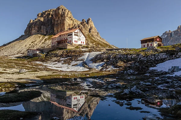 Locatelli refuge reflected in a puddle, Natural Park Three Peaks, Sesto Pusteria
