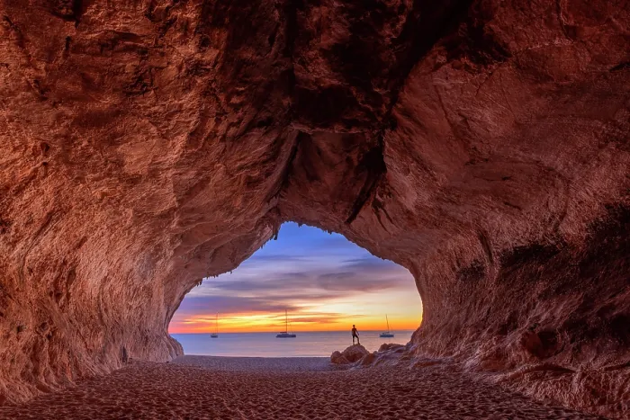 Framed Print : Lonely person looks colors of the sunrise inside the sea cave on the beach of Cala Luna, Baunei, Ogliastra province, Sardinia, Italy (MR) Framed Print : Lonely person looks colors of the sunrise inside the sea cave on the beach of Cala Luna, Baunei, Ogliastra province, Sardinia, Italy (MR)