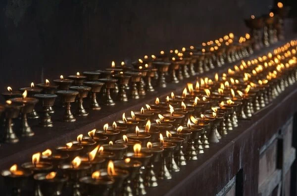 A long line of butter lamps burning at the Changangkha Temple, a fine 15th century temple